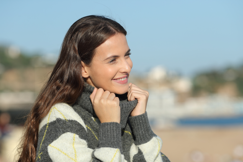 Happy,Woman,Wearing,Jersey,Contemplating,Views,Sitting,In,A,Coast