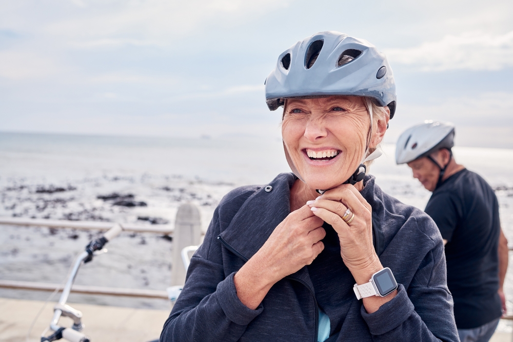 Happy,Senior,Woman,,Bicycle,And,Helmet,On,Holiday,Ride,At